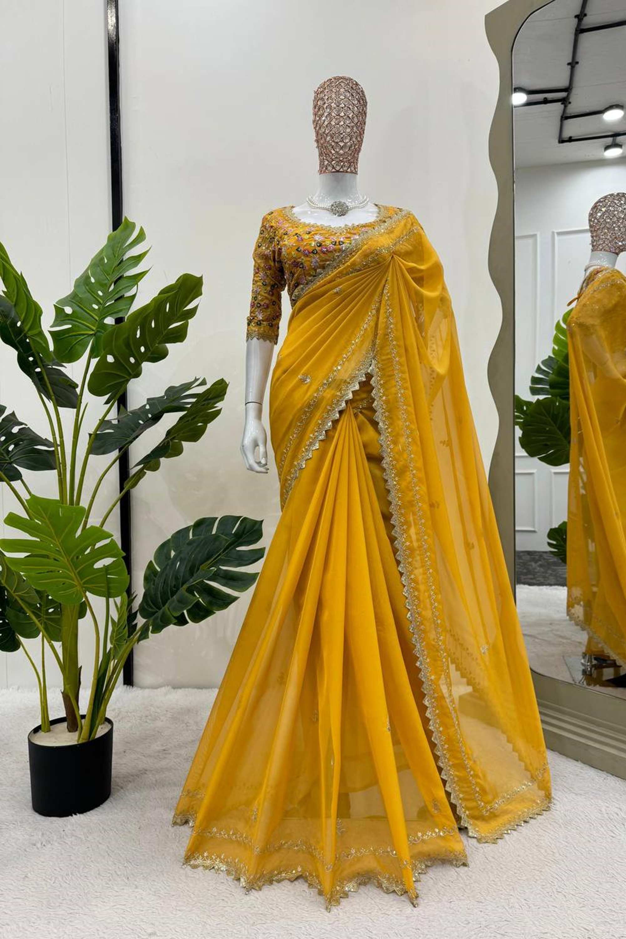 Elegant yellow silk saree paired with a beautifully embroidered blouse, showcasing intricate designs and vibrant colors