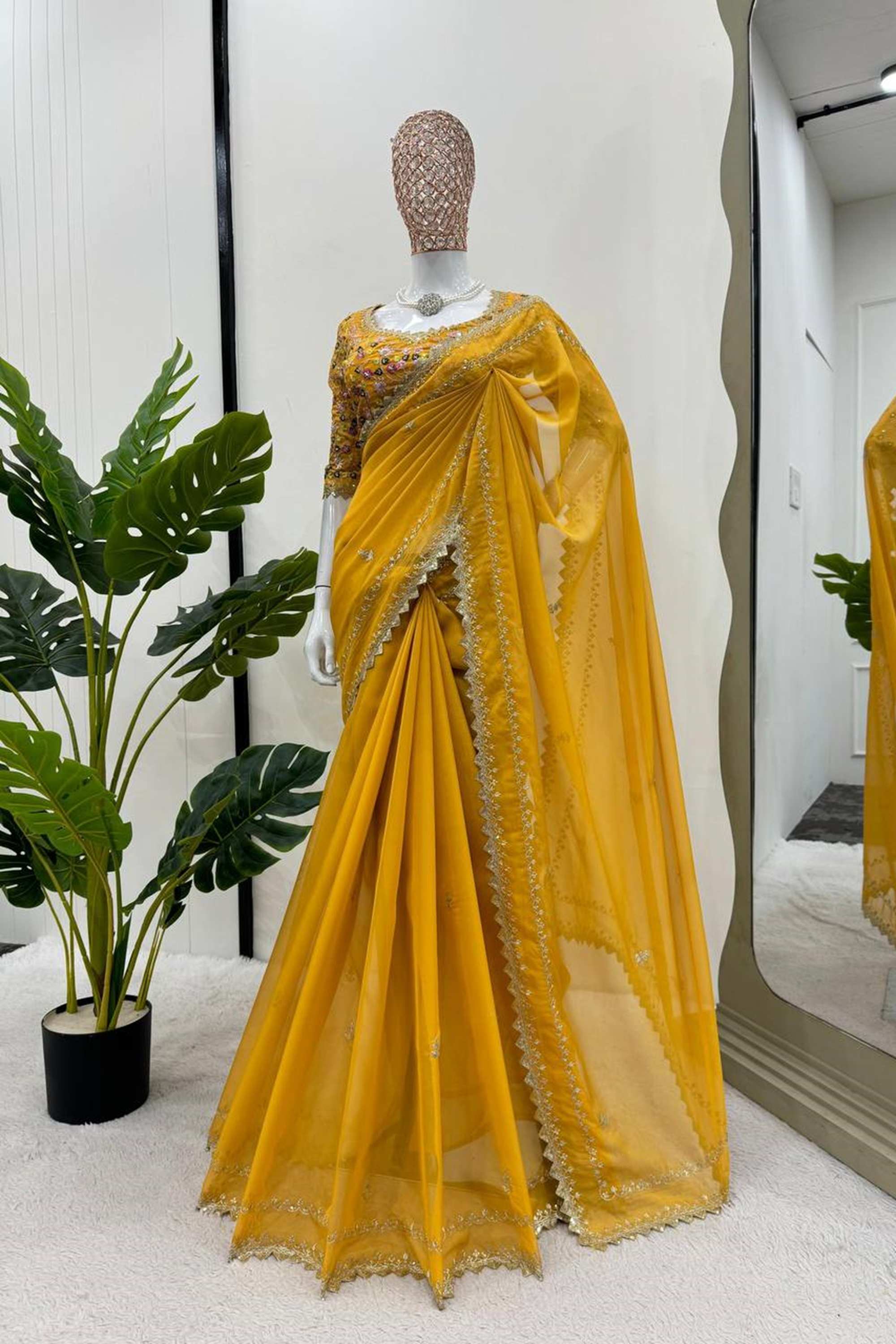 Elegant yellow silk saree paired with a beautifully embroidered blouse, showcasing intricate designs and vibrant colors