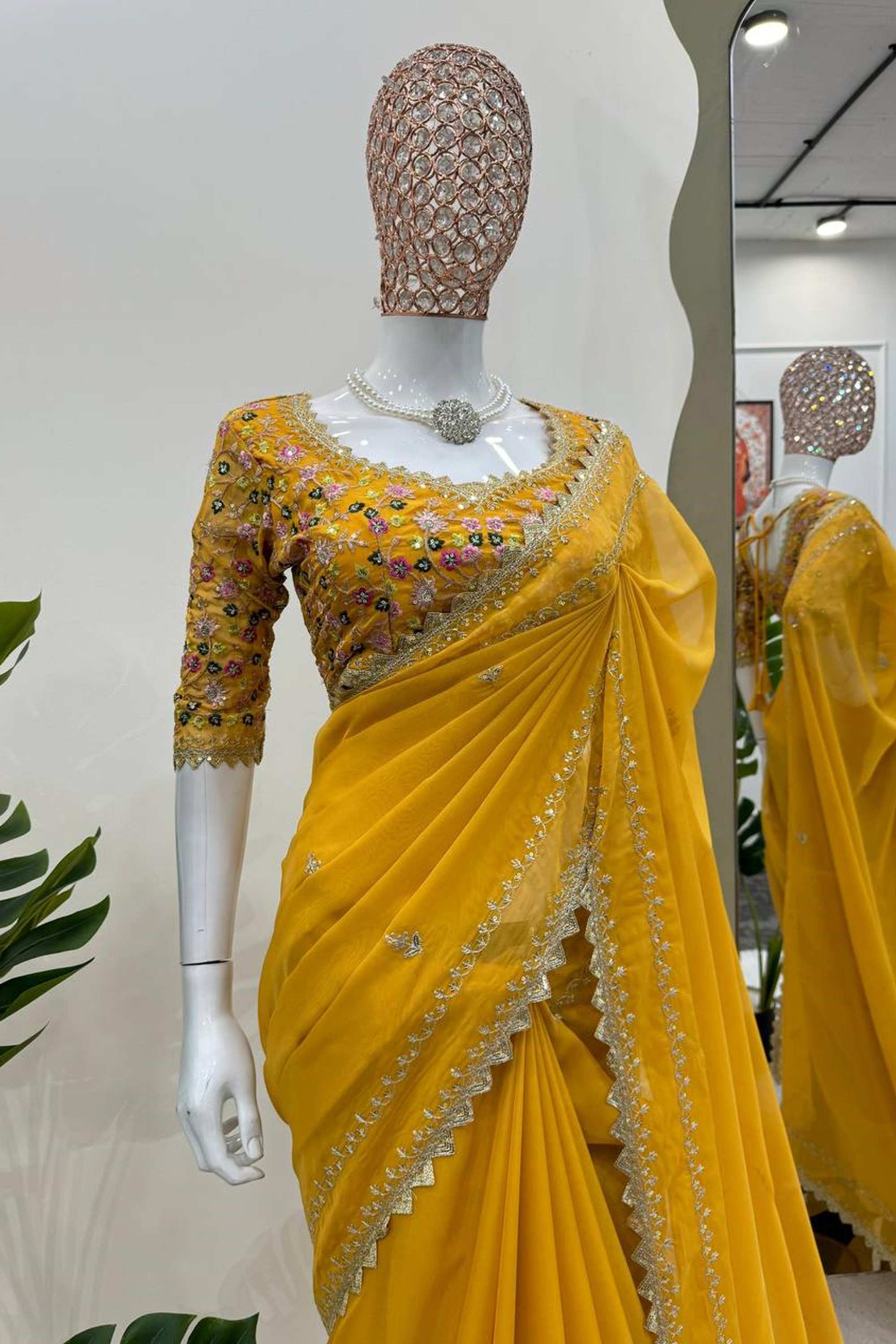 Elegant yellow silk saree paired with a beautifully embroidered blouse, showcasing intricate designs and vibrant colors
