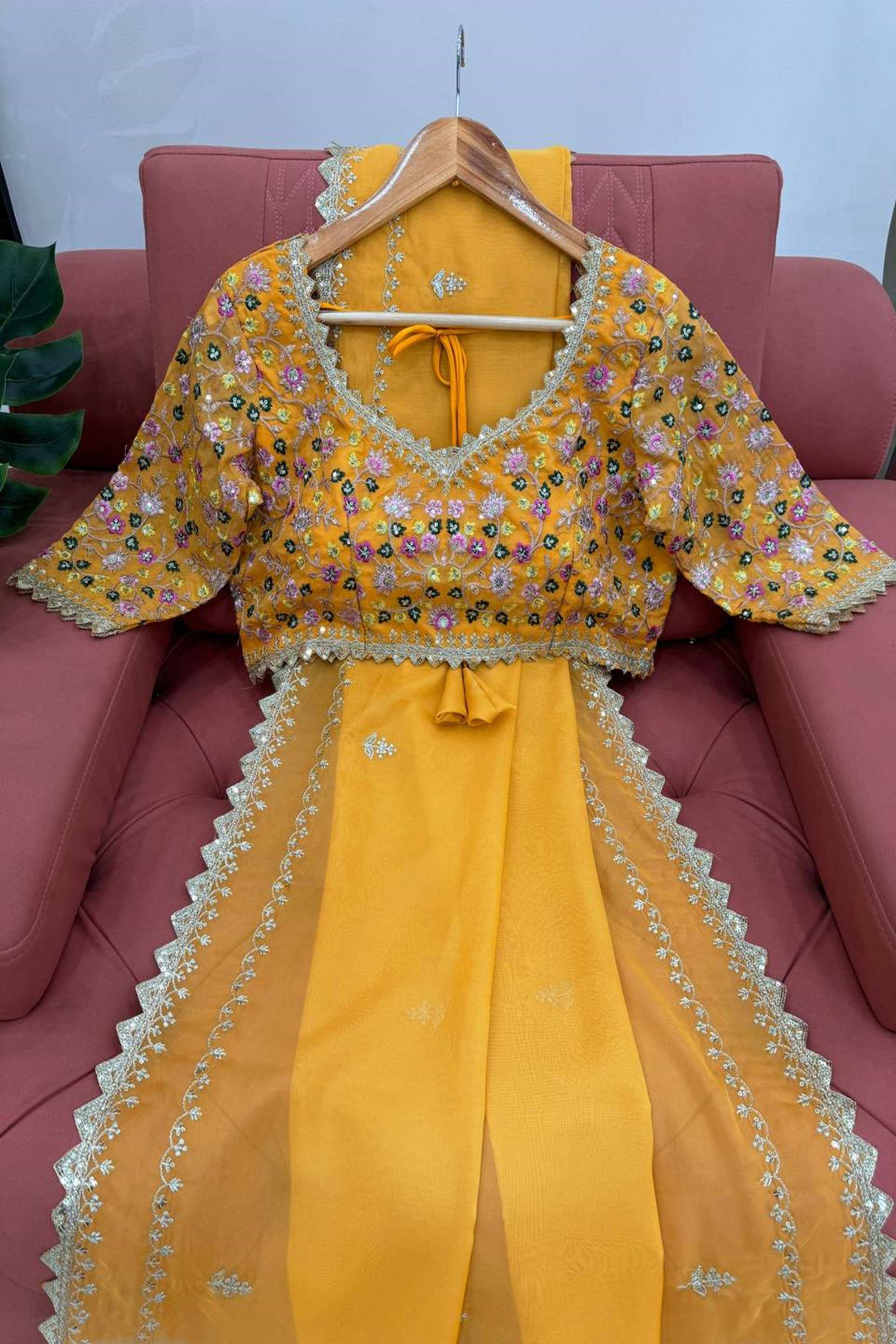 Elegant yellow silk saree paired with a beautifully embroidered blouse, showcasing intricate designs and vibrant colors