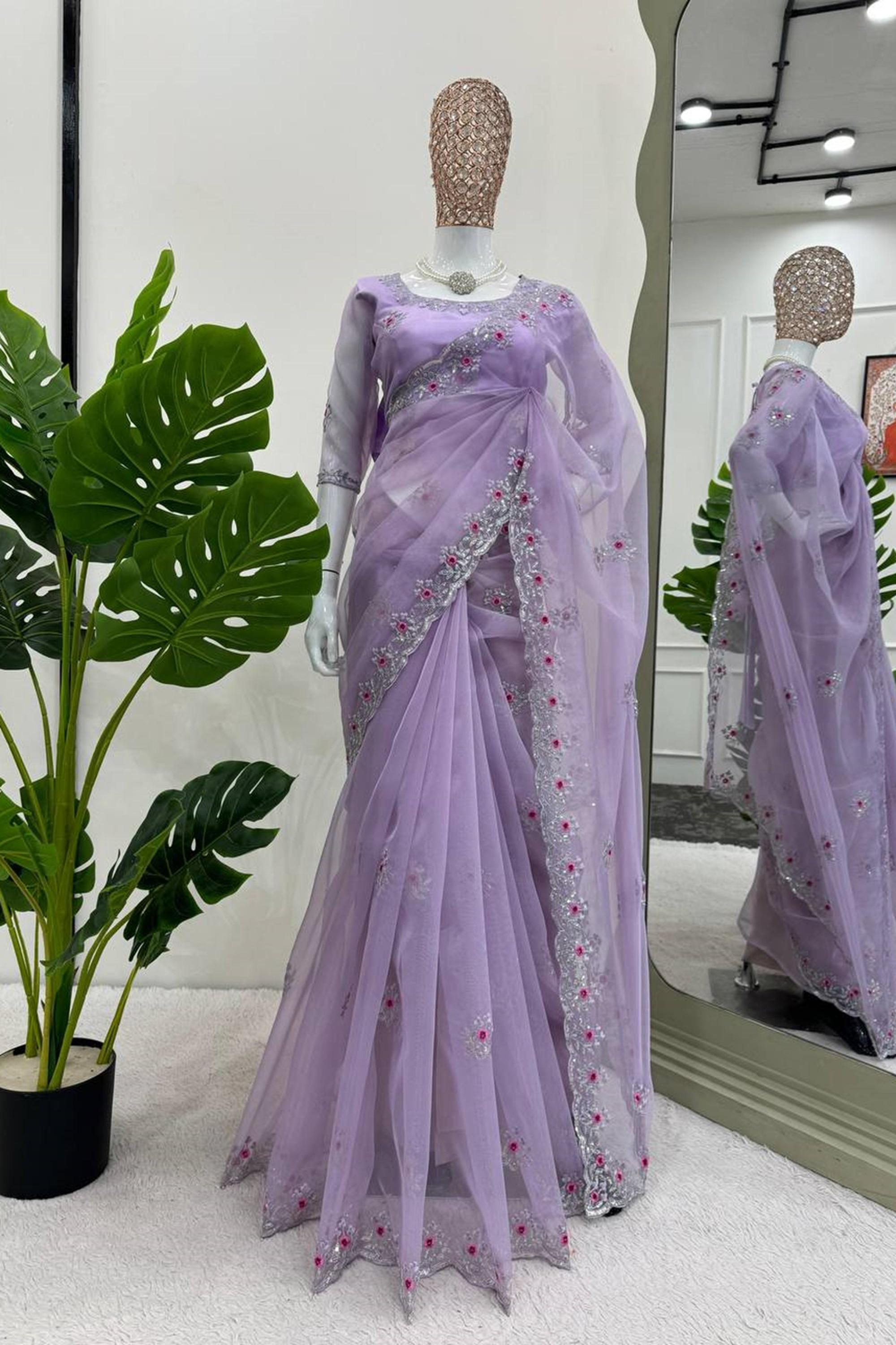 A beautifully embroidered purple sari showcasing intricate designs on both the front and back