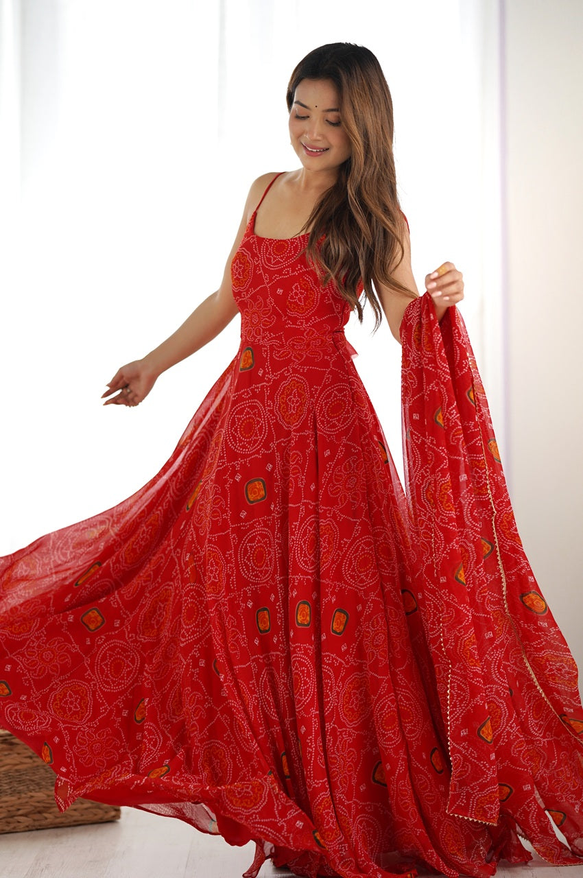 Woman wearing a red floral dress holding a matching scarf against a white background