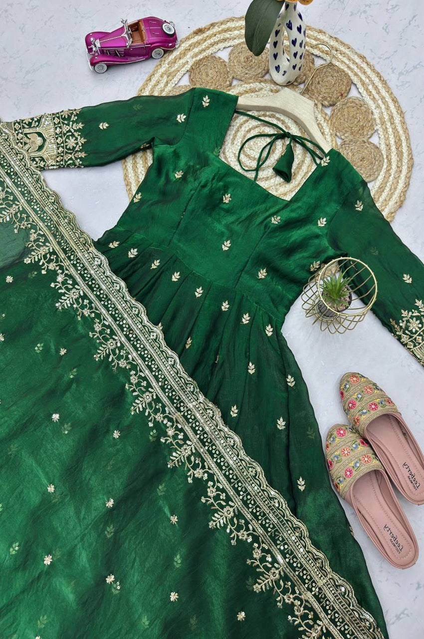 Green embroidered traditional outfit with a matching dupatta on a light background